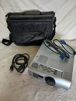 Projector with cables and case overview