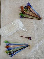 Full view of grouped swizzle sticks on padding