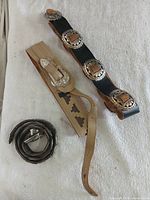 All three belts laid out on fabric surface