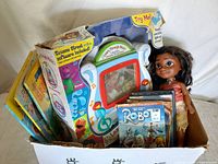Box containing Moana doll, Learn Through Music system in packaging, books and DVD cases