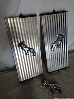 Two mirror frames with bulldog emblems and one bulldog ornament on surface