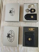 Two closed and two open Maui Charity Classic boxes displaying contents