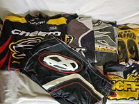 Stacked view of five jerseys and one pair of pants