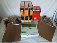 Lot overview of clipboards, binders, staples box, ink cartridge box