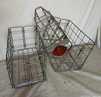 Overview of three silver Schwinn wire pieces: two baskets and rack with reflector