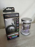 StepFX tracker box beside LED bangle watch case