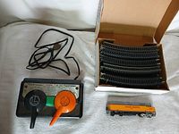 Overall lot view showing transformer, locomotive, and box of curved track