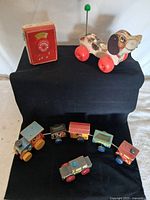 Group shot showing all four toys: Snoopy Sniffer, pocket radio, circus train, police car