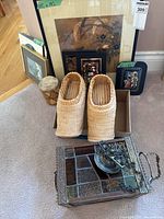 Group shot showing all items: framed artworks, wicker clogs in box, stained glass shade, small wood container