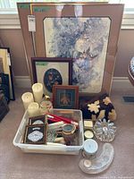 Group shot of framed art, candles, glass holders and pillow