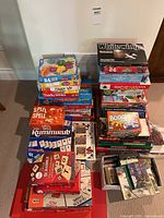 Overall shot of three stacks of board games on floor