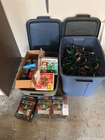 Two totes with boxed and loose Christmas lights