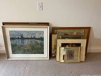 Group of six framed artworks against wall
