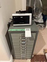 Drawer cabinet with RCA alarm clock on top