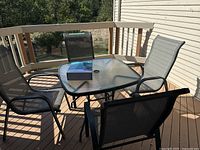Patio set on deck showing table and four chairs