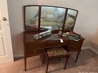 Full view vanity, stool, mirror, contents on top