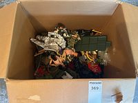 Box containing assorted action figures and accessories
