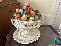 Complete tureen assembled with lid and platter on surface