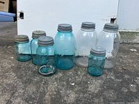 All seven jars lined up showing relative sizes and lid types