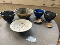 Group shot of all seven pottery pieces on table