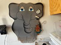 Full view of elephant bulletin board and wooden hanger on wall