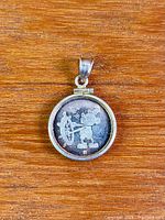 Full view of pendant obverse depicting Mickey at wheel