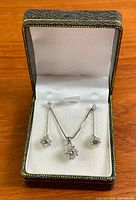 Necklace and earrings displayed inside presentation box