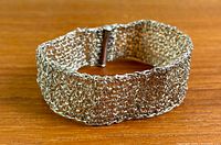 Full view of silver mesh bracelet on surface