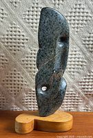 front view of marble sculpture on wood base