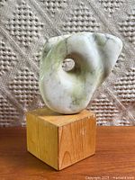 Full view of marble sculpture on wood plinth