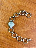 Entire watch laid flat showing bracelet and case