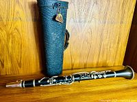 Clarinet fully assembled in front of cylindrical case