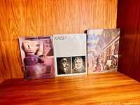 Front view of all three hardcover art books on shelf