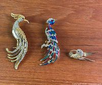 All three bird brooches displayed