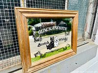 Full view of framed advertising mirror