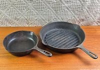 Both cast iron skillets side by side on tabletop