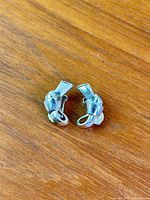 Front view of both silvertone ribbon earrings