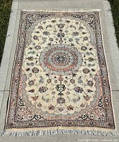 Full view of rug showing design, colours, fringe