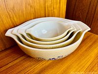 Four nested Pyrex Homestead Cinderella bowls showing sizes