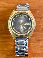 Front view of Seiko DX watch showing dial, day-date, and bracelet