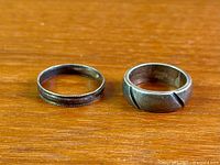 Both sterling silver bands side by side on wood surface