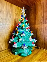 Full view of ceramic Christmas tree with bulbs and base