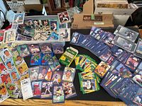 overview of loose cards, sleeved cards, unopened packs and trivia game on table