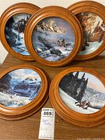 all five framed plates on table