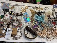 Tabletop view of entire assortment of costume jewelry pieces