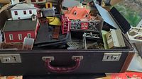 Suitcase filled with HO scale buildings, bridge parts and accessories