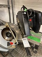 Skil circular saw and Black & Decker chop saw on rack