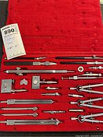 open case showing full set of drafting instruments