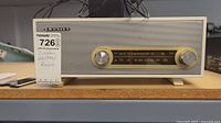 Front view of Crosley cream radio on shelf