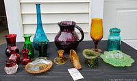 Full group shot showing all sixteen pieces of assorted colored glassware